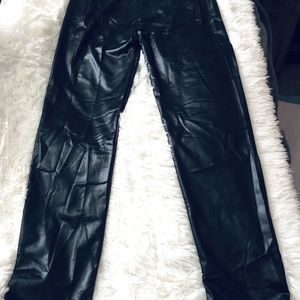 Black leggings that are made to look like leather.